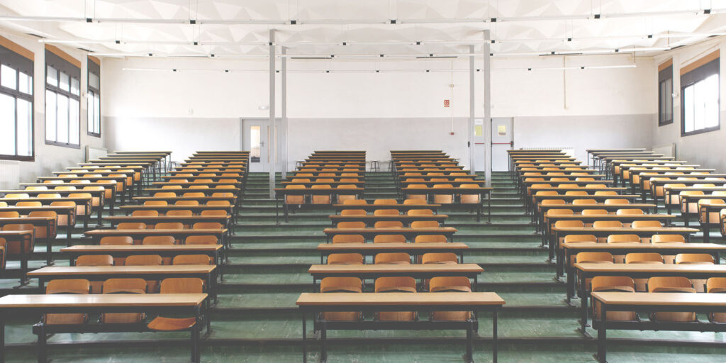 Rows of empty seats in a large lecture hall