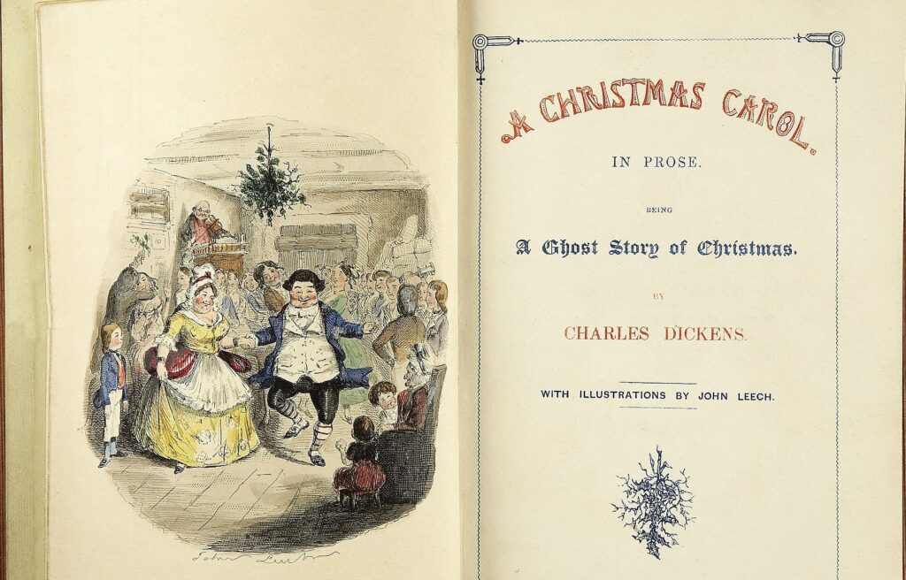 Open book showing the title page of A Christmas Carol by Charles Dickens with an illustration