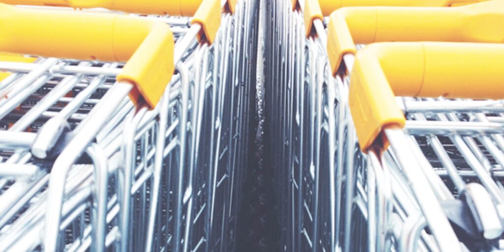 Close-up of stacked shopping carts with yellow handles