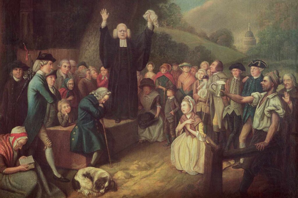 Painting of evangelist George Whitefield preaching outdoors to a large, diverse crowd.